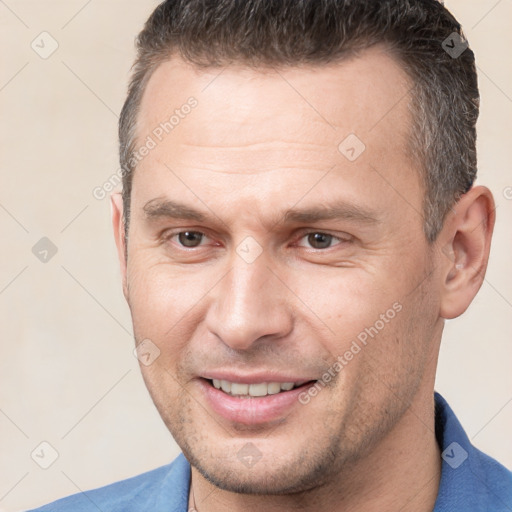 Joyful white adult male with short  brown hair and brown eyes