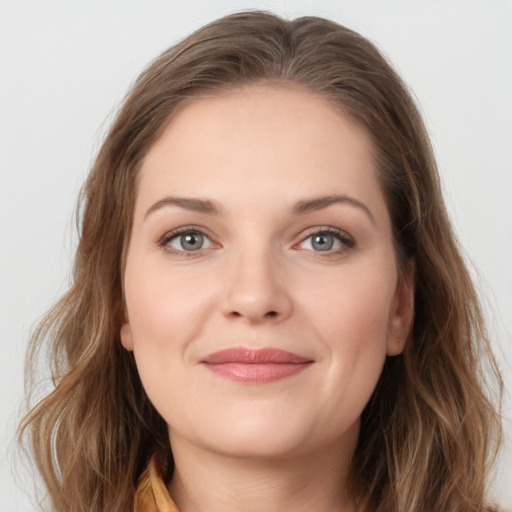 Joyful white young-adult female with long  brown hair and grey eyes