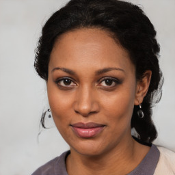 Joyful black young-adult female with medium  brown hair and brown eyes