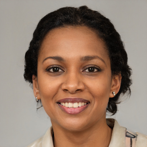 Joyful black young-adult female with medium  brown hair and brown eyes