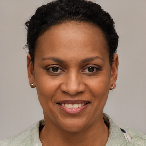 Joyful black young-adult female with short  brown hair and brown eyes