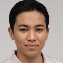 Joyful asian young-adult male with short  brown hair and brown eyes