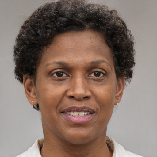 Joyful black adult female with short  brown hair and brown eyes