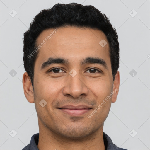 Joyful latino young-adult male with short  black hair and brown eyes