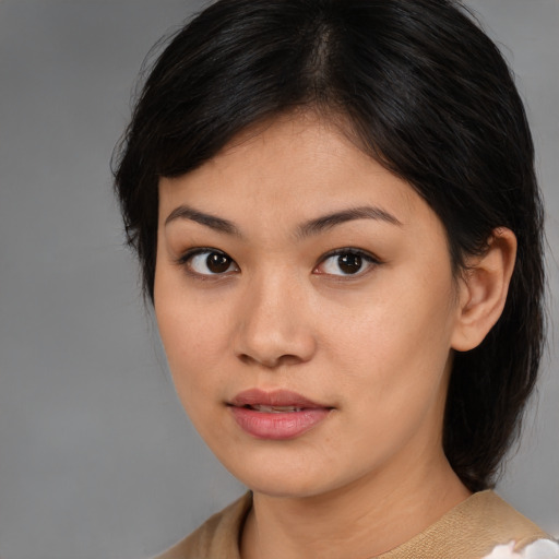 Joyful asian young-adult female with medium  brown hair and brown eyes