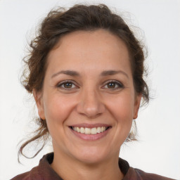 Joyful white adult female with medium  brown hair and brown eyes