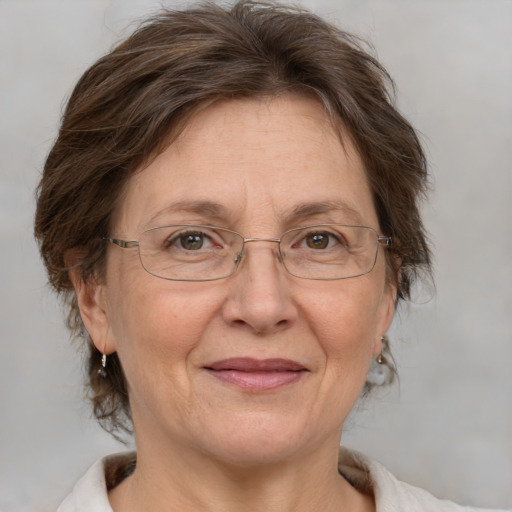 Joyful white middle-aged female with medium  brown hair and grey eyes