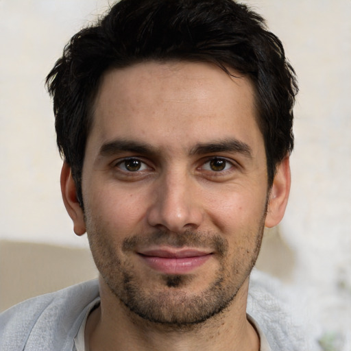 Joyful white young-adult male with short  black hair and brown eyes