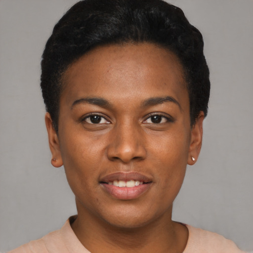 Joyful black young-adult female with short  black hair and brown eyes