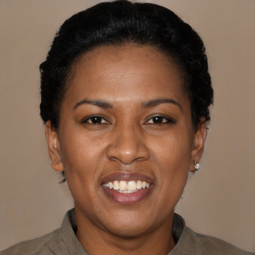 Joyful latino young-adult female with short  black hair and brown eyes