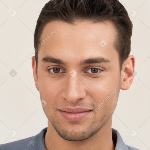 Joyful white young-adult male with short  brown hair and brown eyes