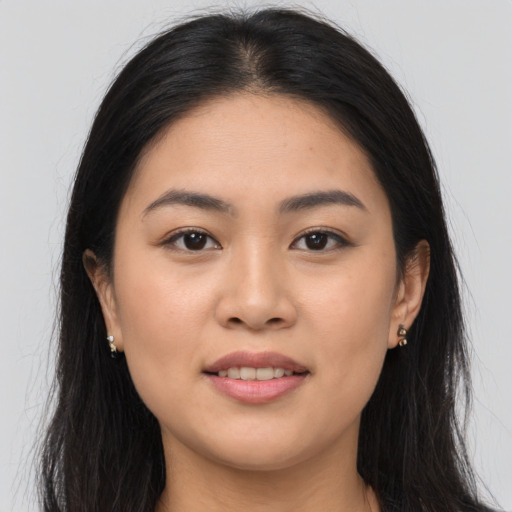 Joyful asian young-adult female with long  brown hair and brown eyes