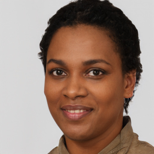 Joyful black young-adult female with short  brown hair and brown eyes