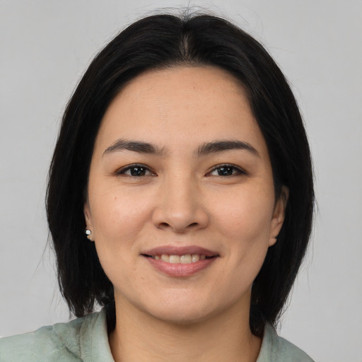 Joyful asian young-adult female with medium  black hair and brown eyes