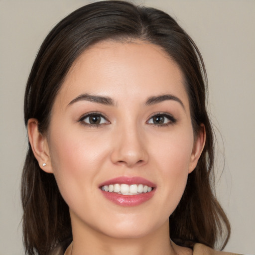 Joyful white young-adult female with medium  brown hair and brown eyes