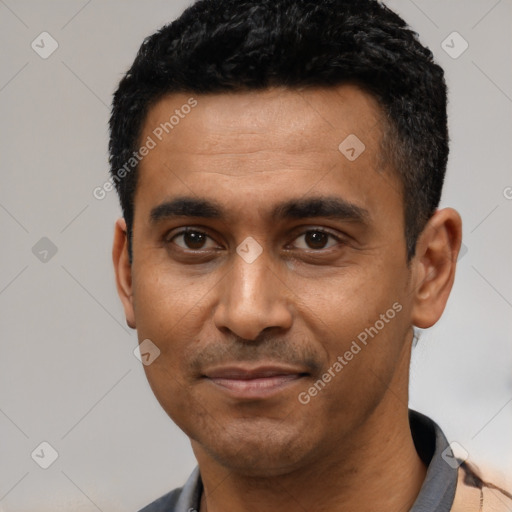 Joyful latino young-adult male with short  black hair and brown eyes