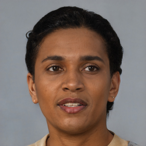 Joyful black young-adult male with short  black hair and brown eyes