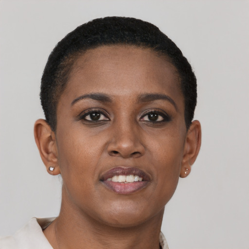 Joyful black young-adult female with short  brown hair and brown eyes