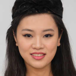 Joyful asian young-adult female with long  brown hair and brown eyes