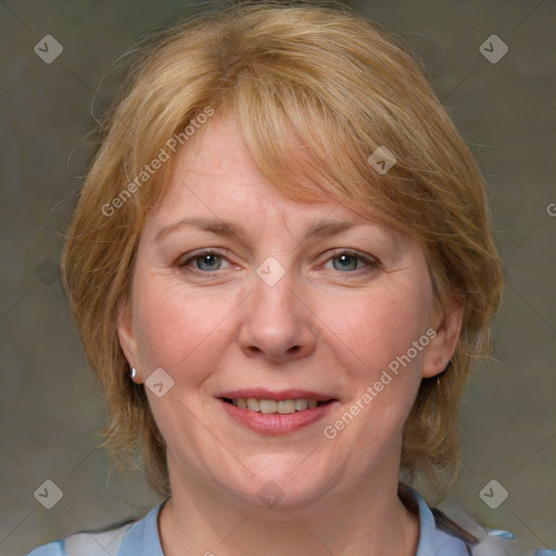 Joyful white adult female with medium  brown hair and blue eyes