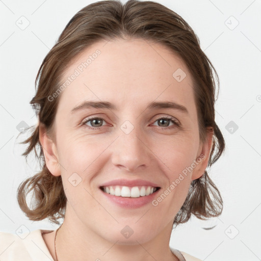 Joyful white young-adult female with medium  brown hair and blue eyes