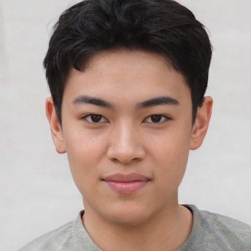 Joyful asian young-adult male with short  black hair and brown eyes