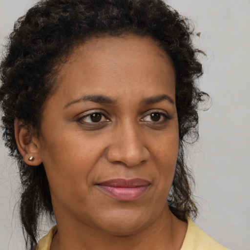 Joyful black adult female with short  brown hair and brown eyes