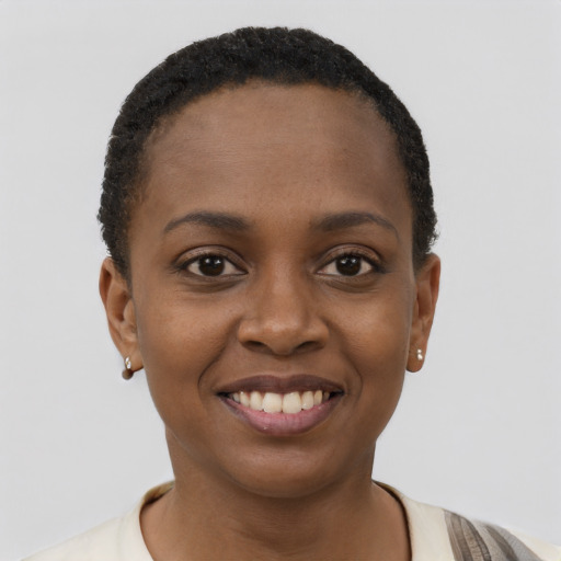 Joyful black young-adult female with short  brown hair and brown eyes