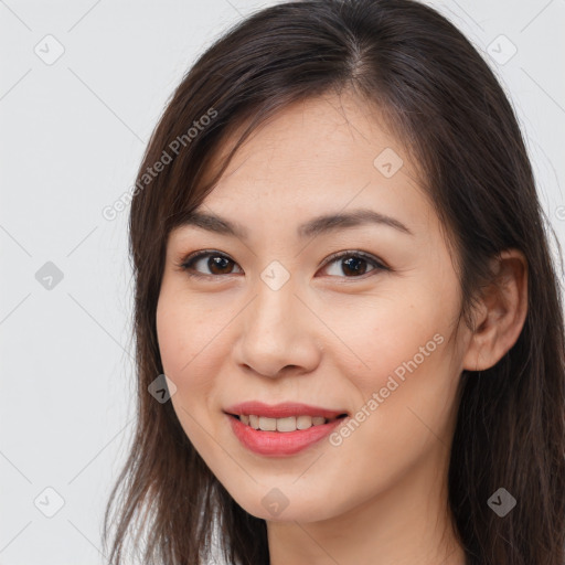 Joyful white young-adult female with long  brown hair and brown eyes