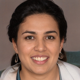 Joyful white young-adult female with medium  brown hair and brown eyes