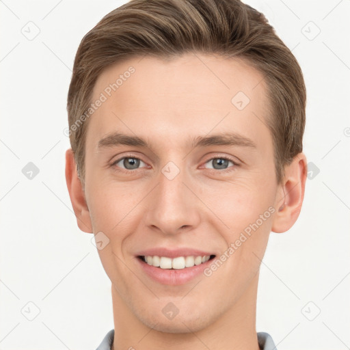 Joyful white young-adult male with short  brown hair and grey eyes