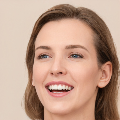 Joyful white young-adult female with long  brown hair and green eyes