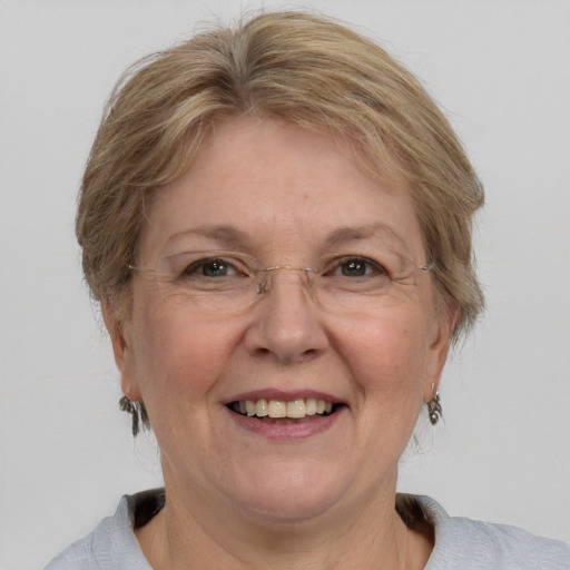 Joyful white middle-aged female with medium  brown hair and blue eyes