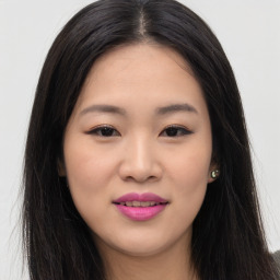 Joyful asian young-adult female with long  brown hair and brown eyes