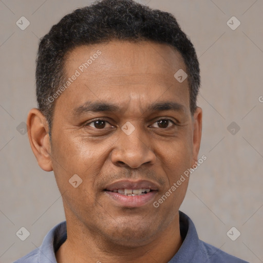 Joyful latino adult male with short  brown hair and brown eyes