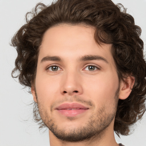 Joyful white young-adult male with medium  brown hair and brown eyes