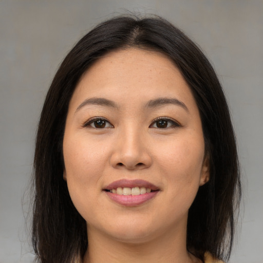 Joyful asian young-adult female with long  brown hair and brown eyes