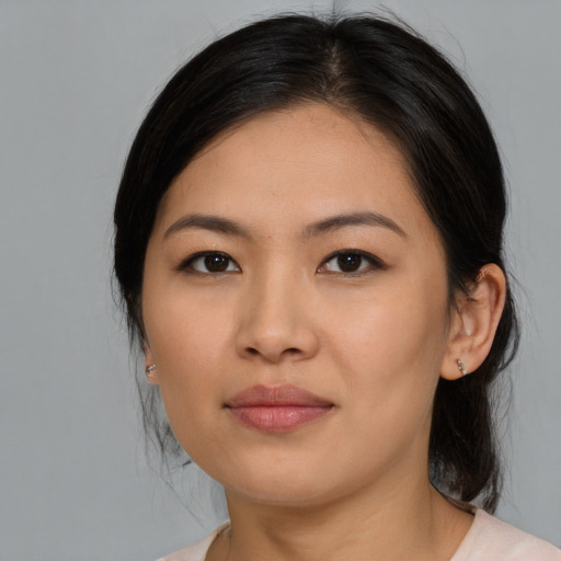 Joyful asian young-adult female with medium  brown hair and brown eyes