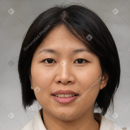 Joyful asian adult female with medium  brown hair and brown eyes