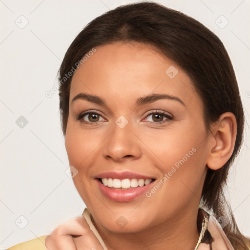 Joyful white young-adult female with long  brown hair and brown eyes