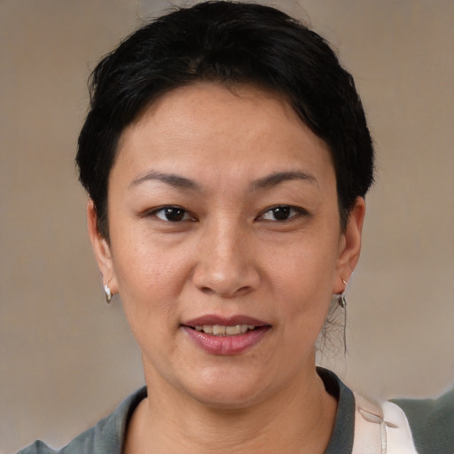 Joyful latino adult female with short  brown hair and brown eyes