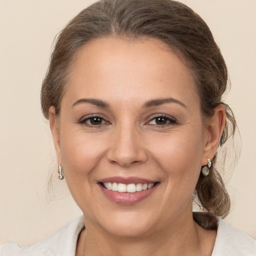 Joyful white young-adult female with medium  brown hair and brown eyes