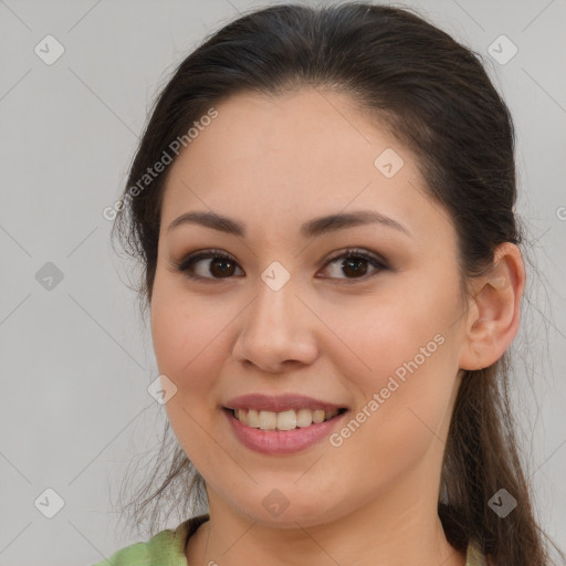 Joyful white young-adult female with long  brown hair and brown eyes