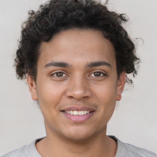 Joyful latino young-adult male with short  brown hair and brown eyes