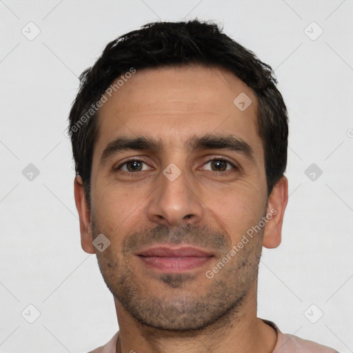 Joyful white young-adult male with short  black hair and brown eyes