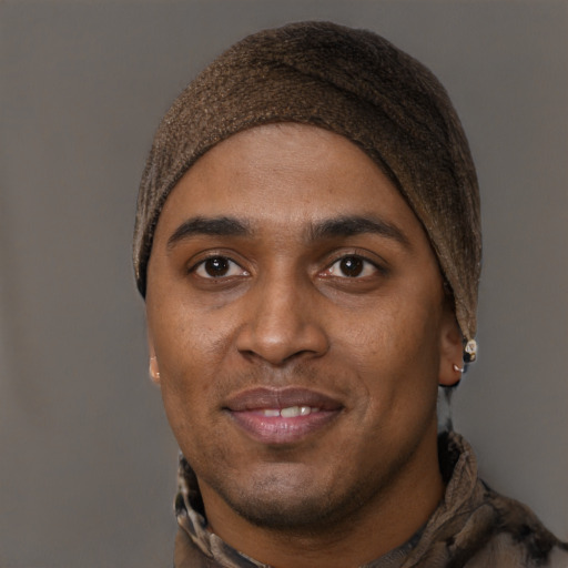 Joyful black young-adult male with short  brown hair and brown eyes