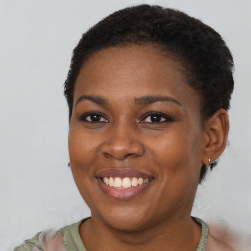 Joyful black young-adult female with short  brown hair and brown eyes