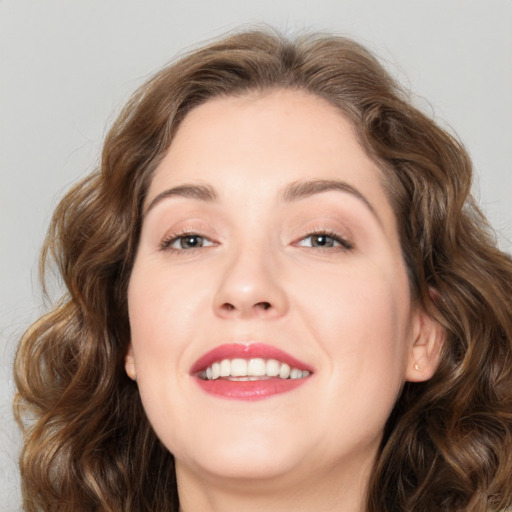 Joyful white young-adult female with medium  brown hair and green eyes