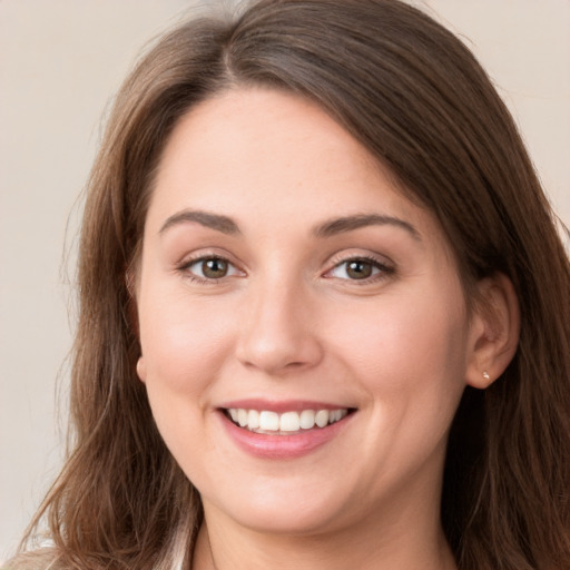 Joyful white young-adult female with long  brown hair and grey eyes