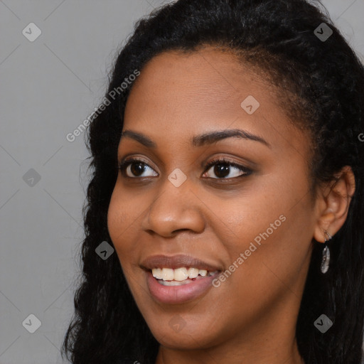 Joyful black young-adult female with long  black hair and brown eyes